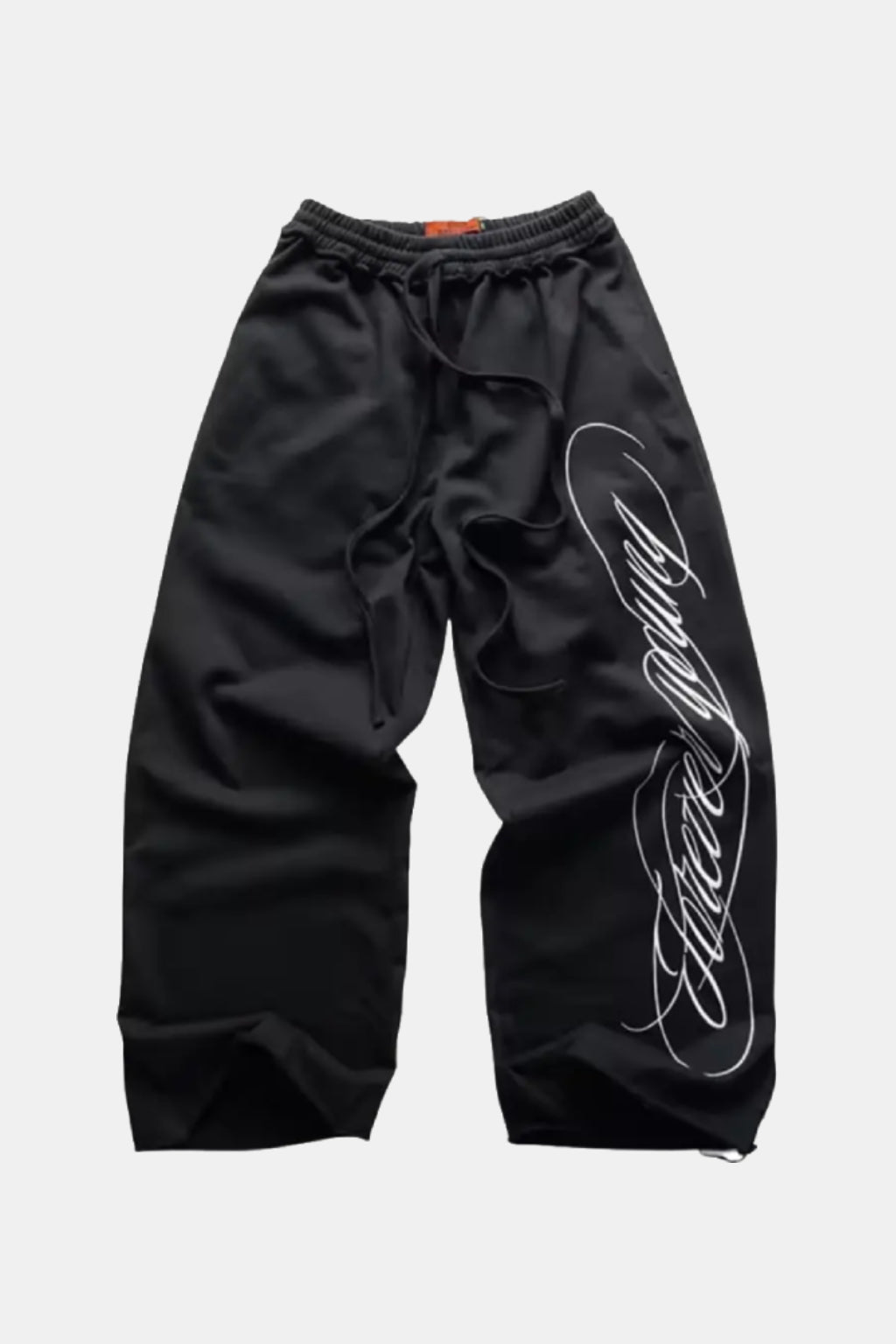 Calligraphy Joggers - black barrel leg joggers with cursive script graphic, front view