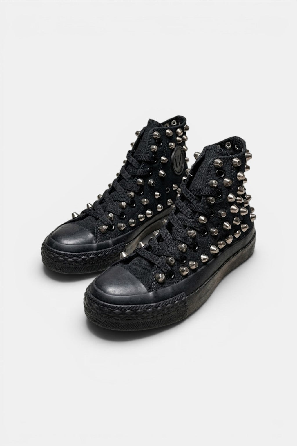 Spiked Shoes - black high top sneakers with sole edge spike detailing, front view